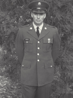 Leonard Burkart standing in front of a tree in his Army uniform