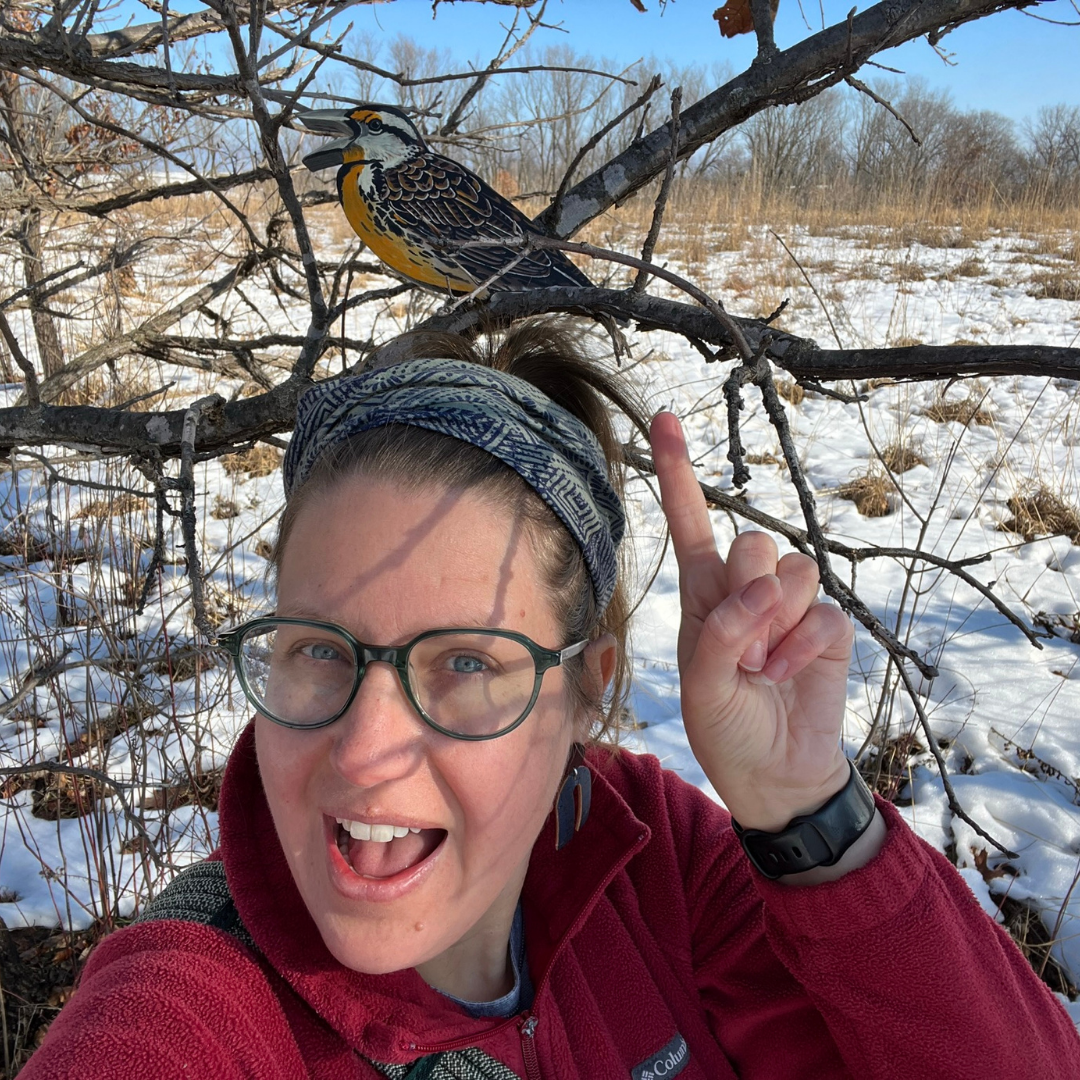 Michelle Wiegand points to wooden bird replica that is part of Avian Adventure program