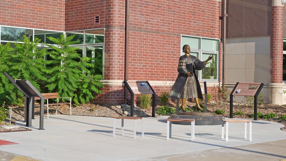 A wide view of the interpretive panels, benches, and statue making up the Dr. Lulu Merle Johnson Plaza.
