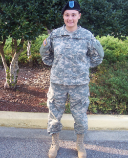 Amanda Jacobson standing at attention in her Army uniform