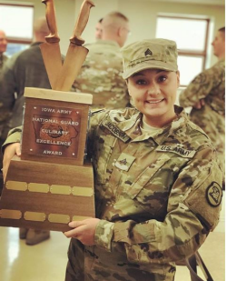 Amanda Jacobson holding an Culinary Excellence Award from the Iowa Army National Guard