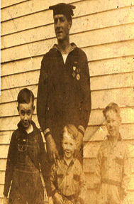 Anthony Arndt standing behind 3 children