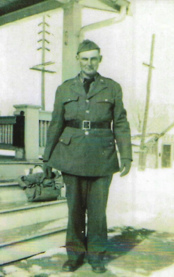 Chuck Benesh standing in front of a house