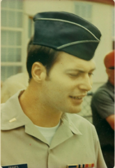 Christopher Graves's wearing his Air Force uniform looking down and smiling