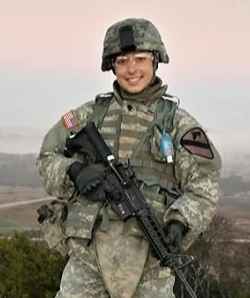 Photo of Damaris Mirea in uniform holding a gun