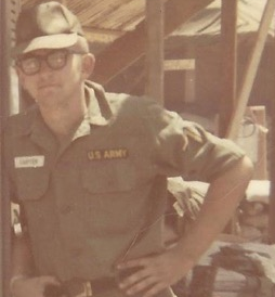 Denny Carter standing outside a building in his Army uniform