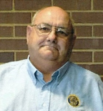 Steven Decker standing in front of a wall smiling years after the war