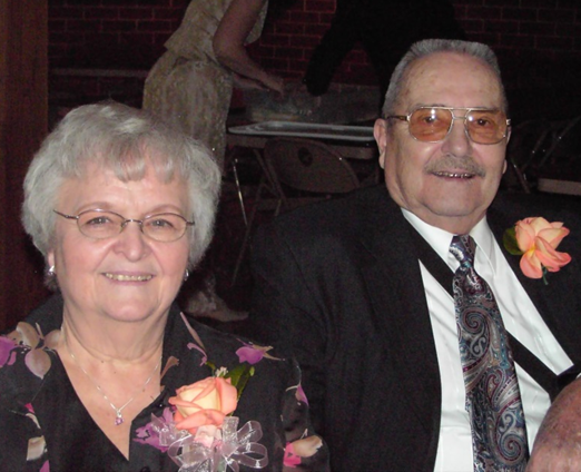 Francis Lacina years later sitting next to his wife, Rita, at a party