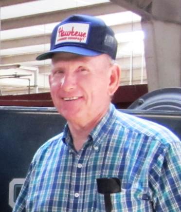 Francis Driscoll smiling wearing an Hawkeye hat years after the war