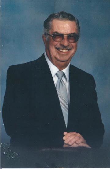 Francis Weipert years later in a professional photo with a blue background