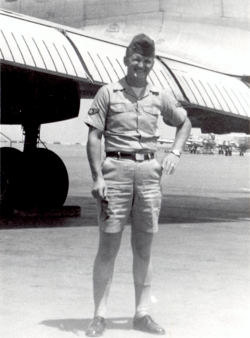 Gary Kellogg standing in front of an airplane wearing his summer Air Force uniform