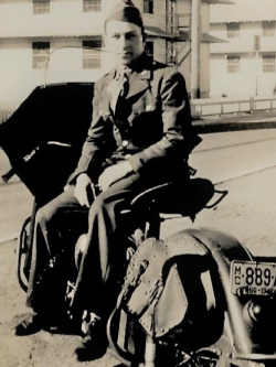 Gene Gerard sitting on a motercycle in his Army uniform