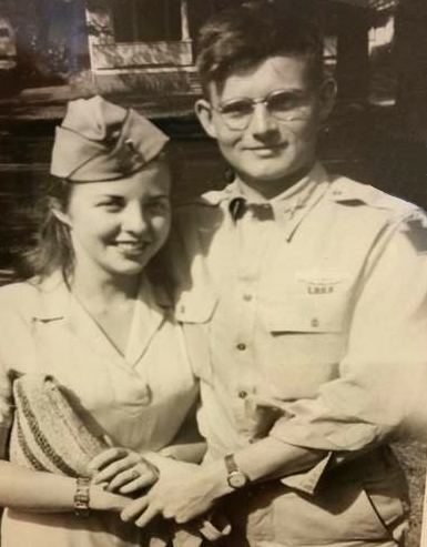 George Dane standing in his military uniform next to his wife who is wearing his hat