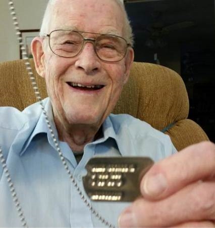 George Dane years after the war showing off his dog tag