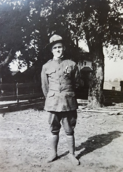 Herman Ruppert standing in a front yard of a house wearing his Army uniform