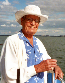 John Leidiger years later on a boat wearing a white hate and blue shirt with palm trees on them