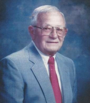 Jaro Lepic years later in a professional photo wearing a blue suit coat and red tie