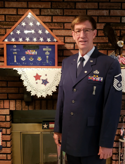 Steven Atcher standing in front of his metals