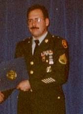 John Mikelson wearing his Army uniform receiveing an award
