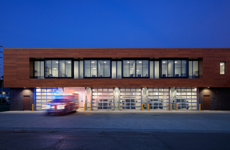 Johnson County AME Building during nighttime hours with an ambulance leaving the garage bay