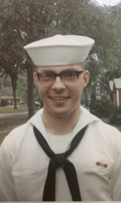 Lawrence Jones standing outside in a neighborhood wearing his Navy uniform and smiling