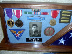 Lee Roy Detweiler's military honors with a picture of his military id photo in the middle and his name tag