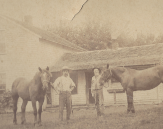 Lyman Bartlett with his horse on a farm