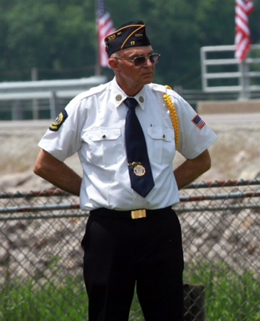 Palmer Holden standing at attention years after the war at an event