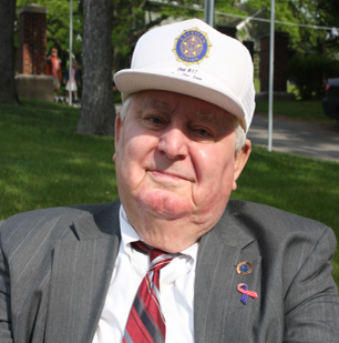 Ralph Neuzil years later wearing a suit and white hat