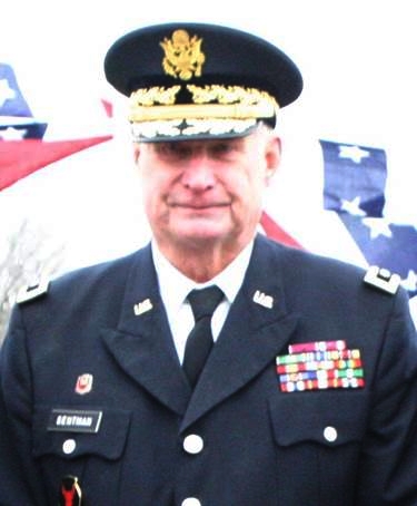 Robert Sentman standing in front of the American flag wearing his Major General uniform