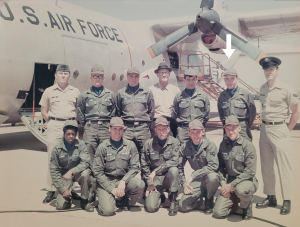 photo of Ron Reihman in uniform in front of a plane