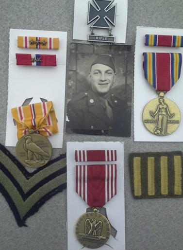 Royo Foens' military photo surrounded by his metals