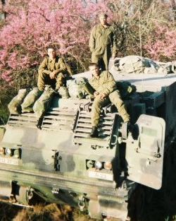 Thomas Webber and fellow soliders sitting on a tank
