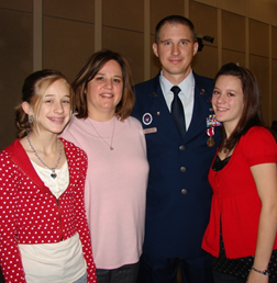 Dawn Bosneiler standing with her husband and 2 daughters