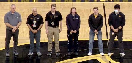 Photo of life saving first responders being recognized at a University of Iowa men's basketball game