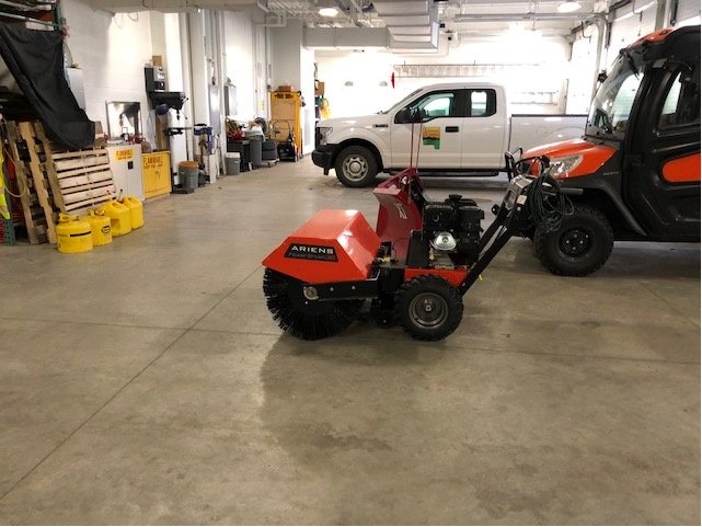 Photo of a rotating brush used to clear sidewalks near county buildings