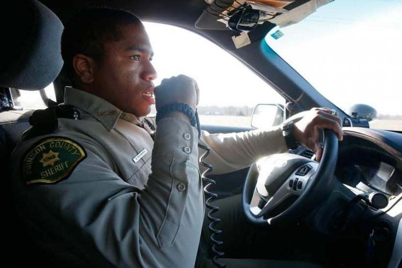 Sheriff talking on his radio while driving