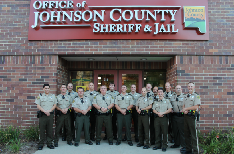 Officers lined up in front of the johnson county sheriff building